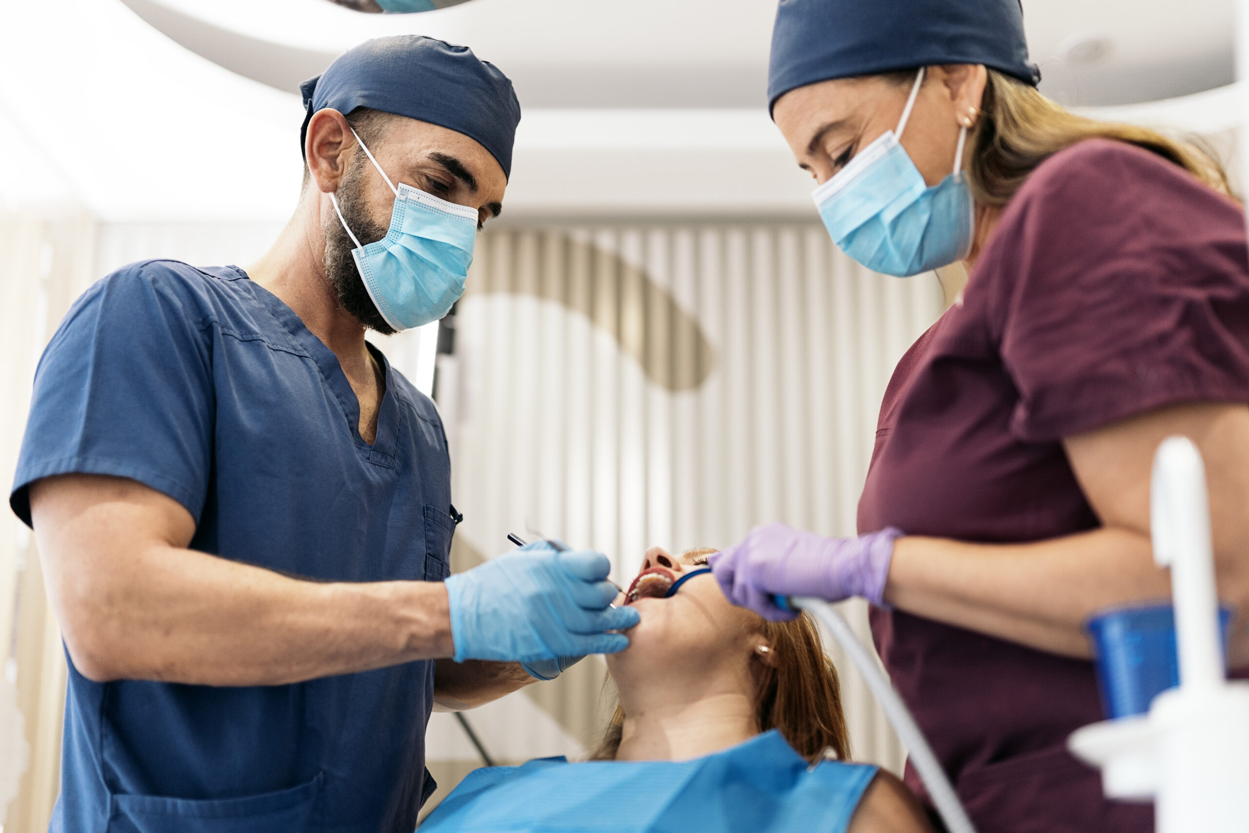 A woman receiving out-of-pocket dental cleaning