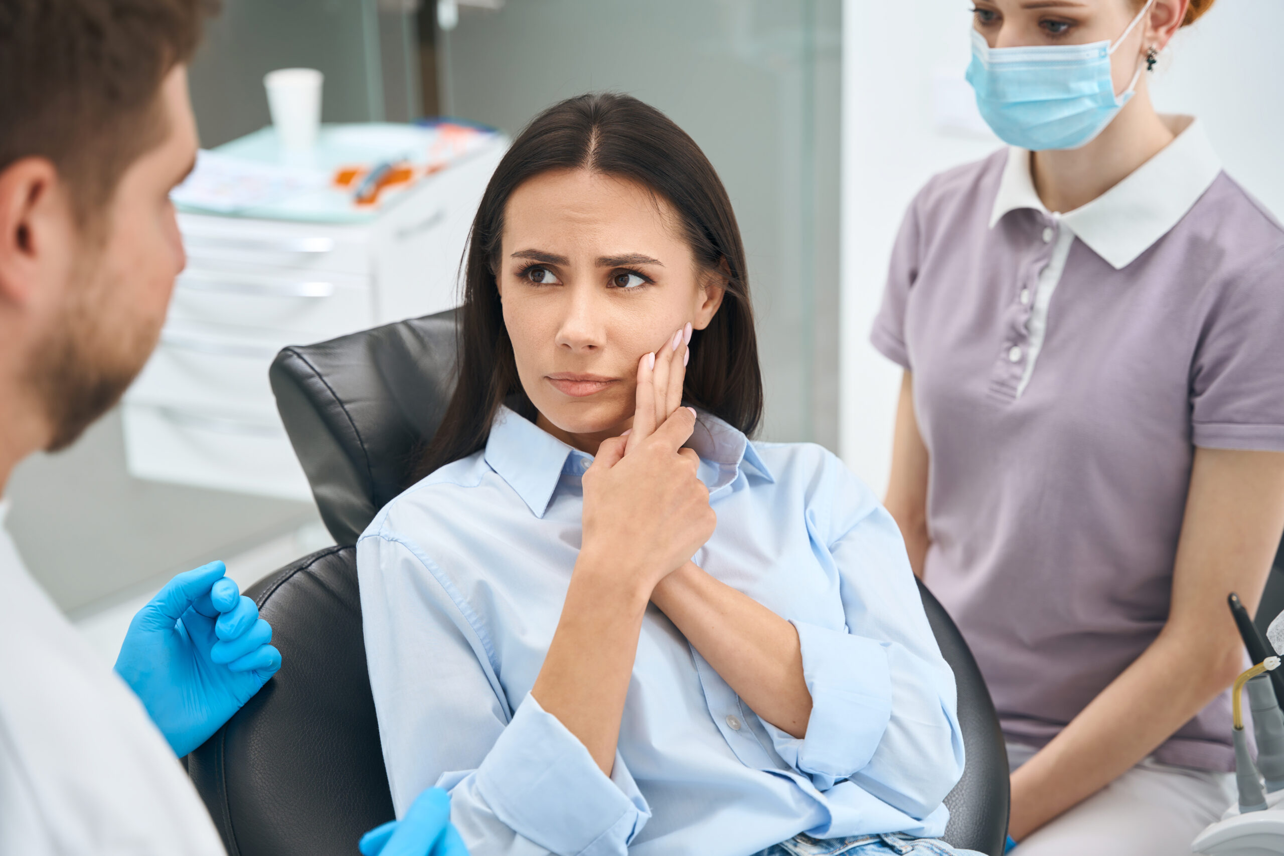 A concerned patient wondering, "will a dentist pull a tooth without insurance?"