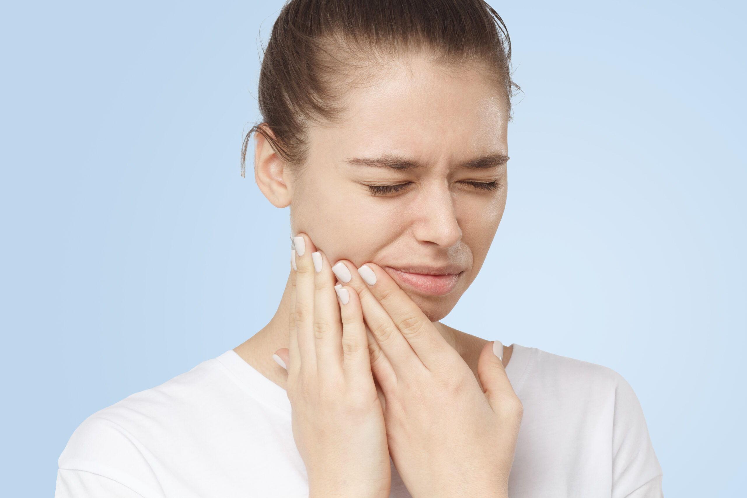 A woman in need of tooth extraction pain relief