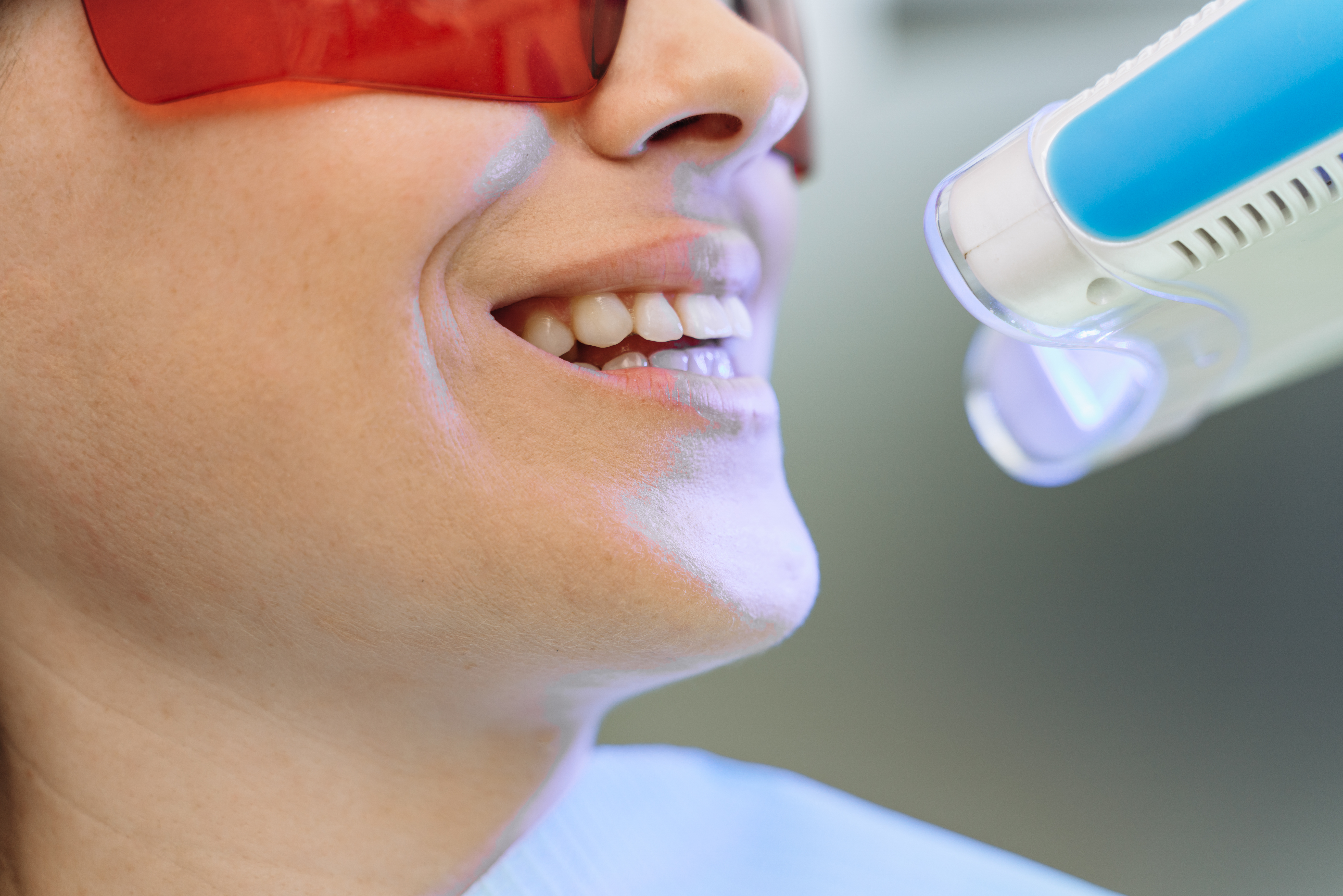 A happy female patient after searching, "zoom teeth whitening near me."