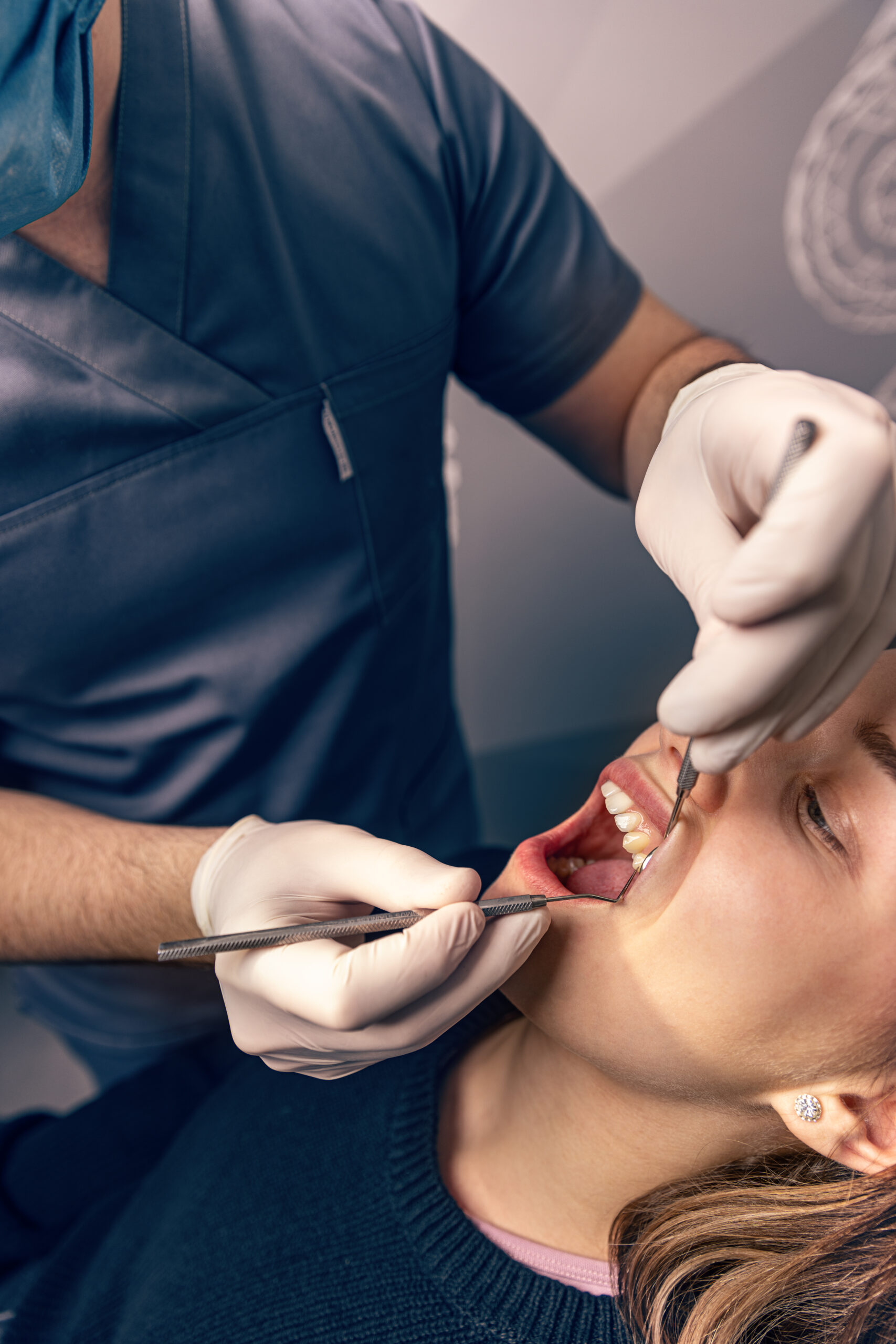 A woman in the process of a tooth extraction near me