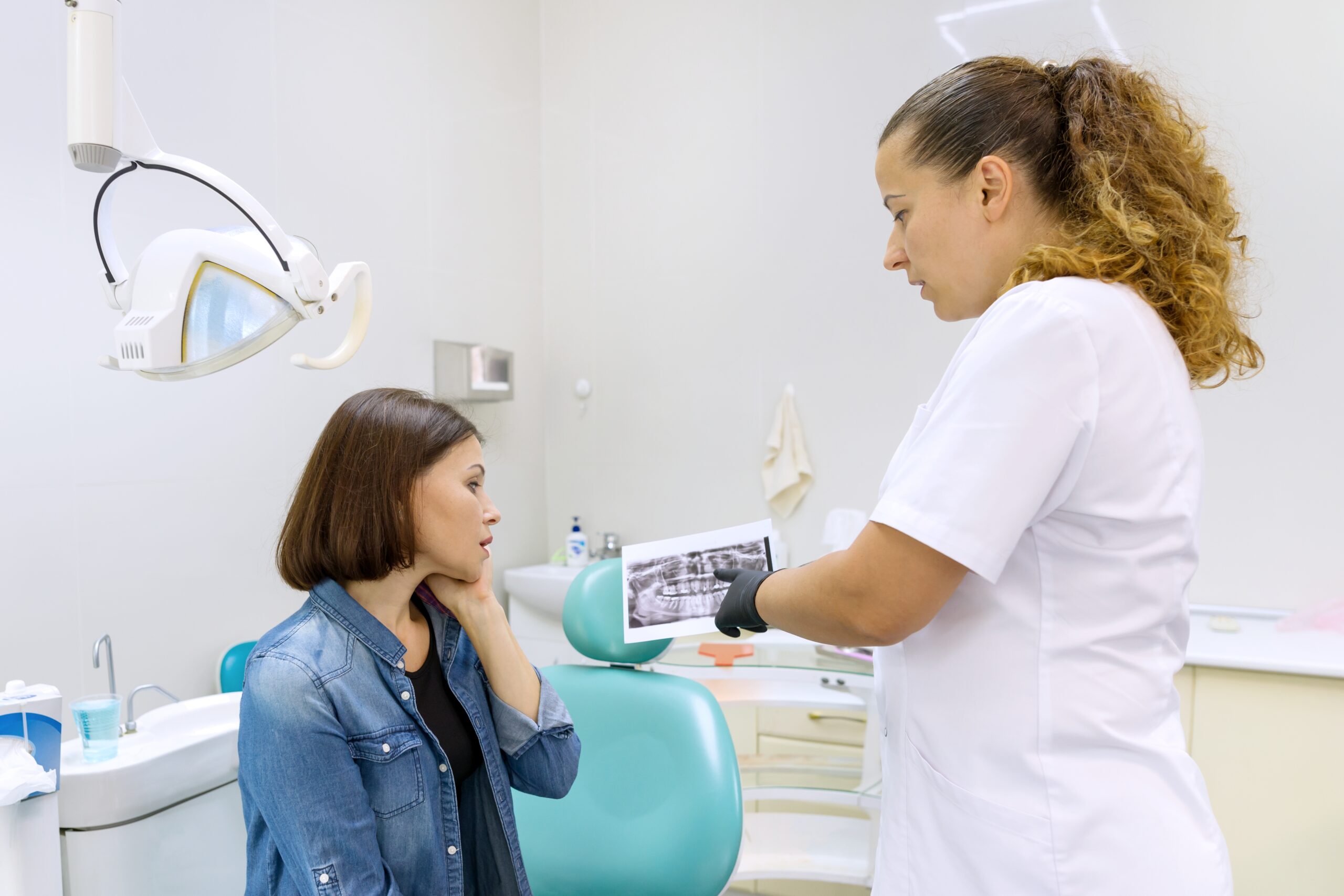 A patient learning about the tooth extraction healing process