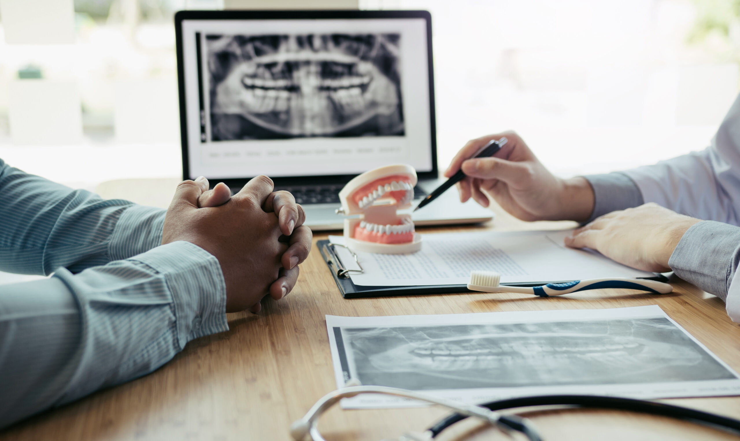 A patient asking a dentist, "is it worth it to have dental insurance?"