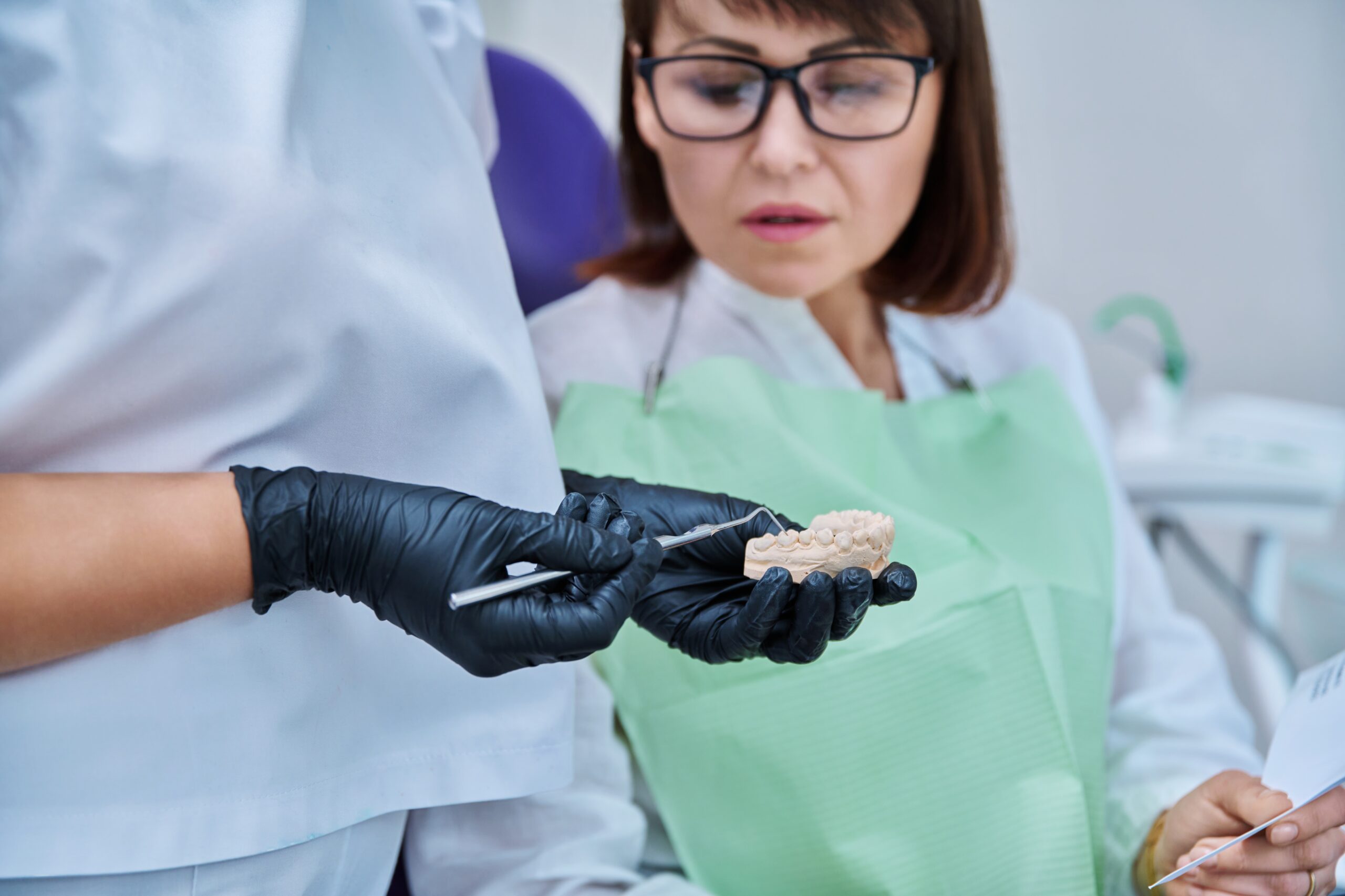 A woman learning about tooth extraction costs without insurance