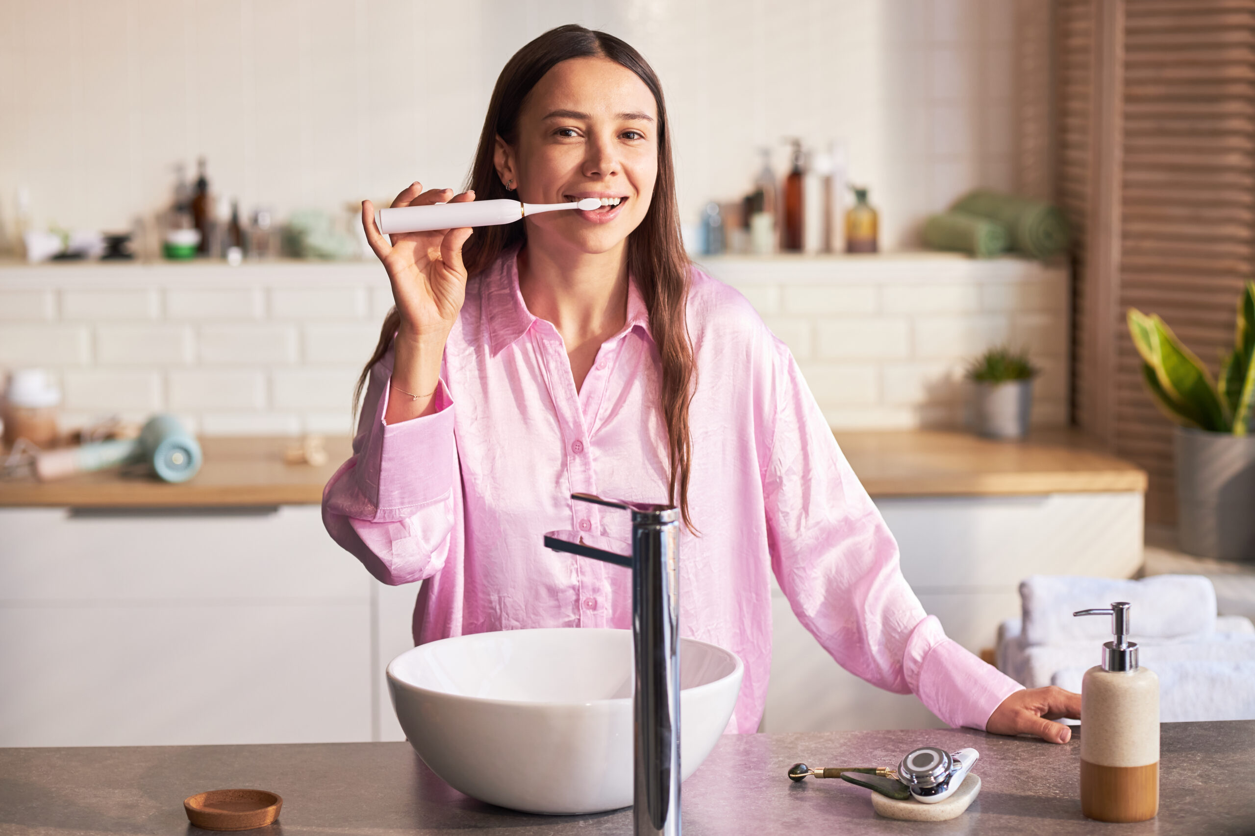 A woman performing teeth cleaning at home