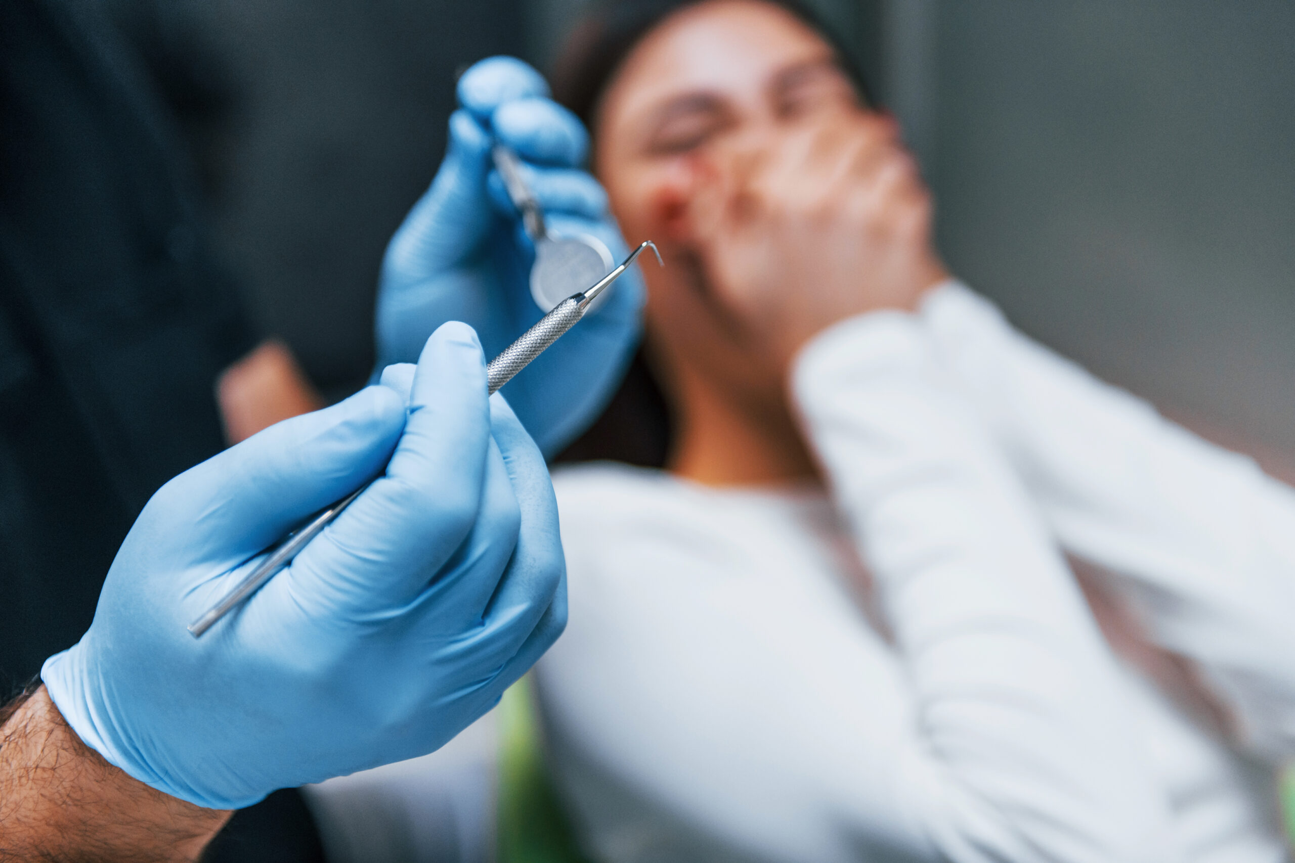 A scared woman experiencing tooth extraction bleeding after a procedure