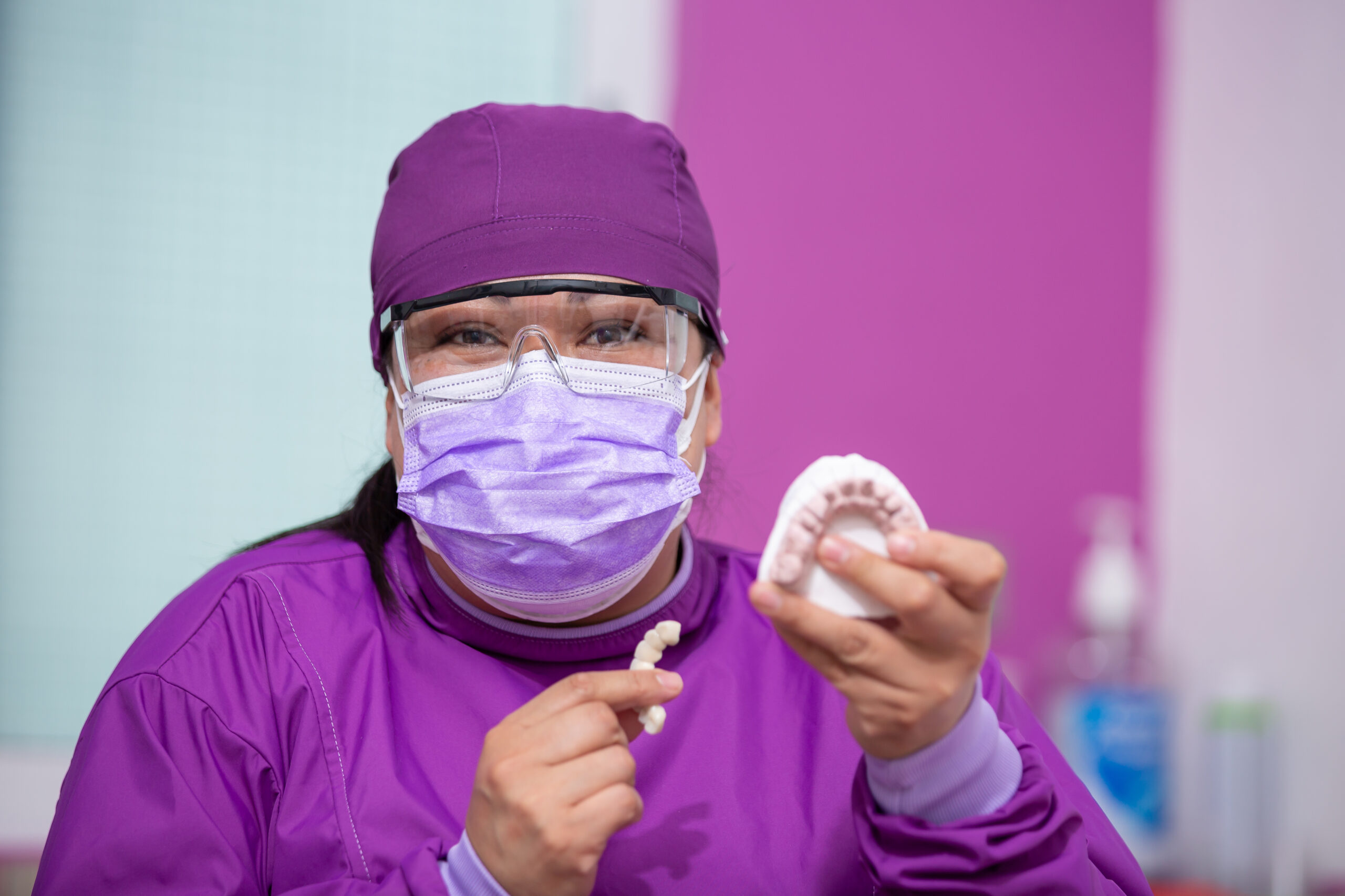 A dentist explaining how much a tooth cap costs.