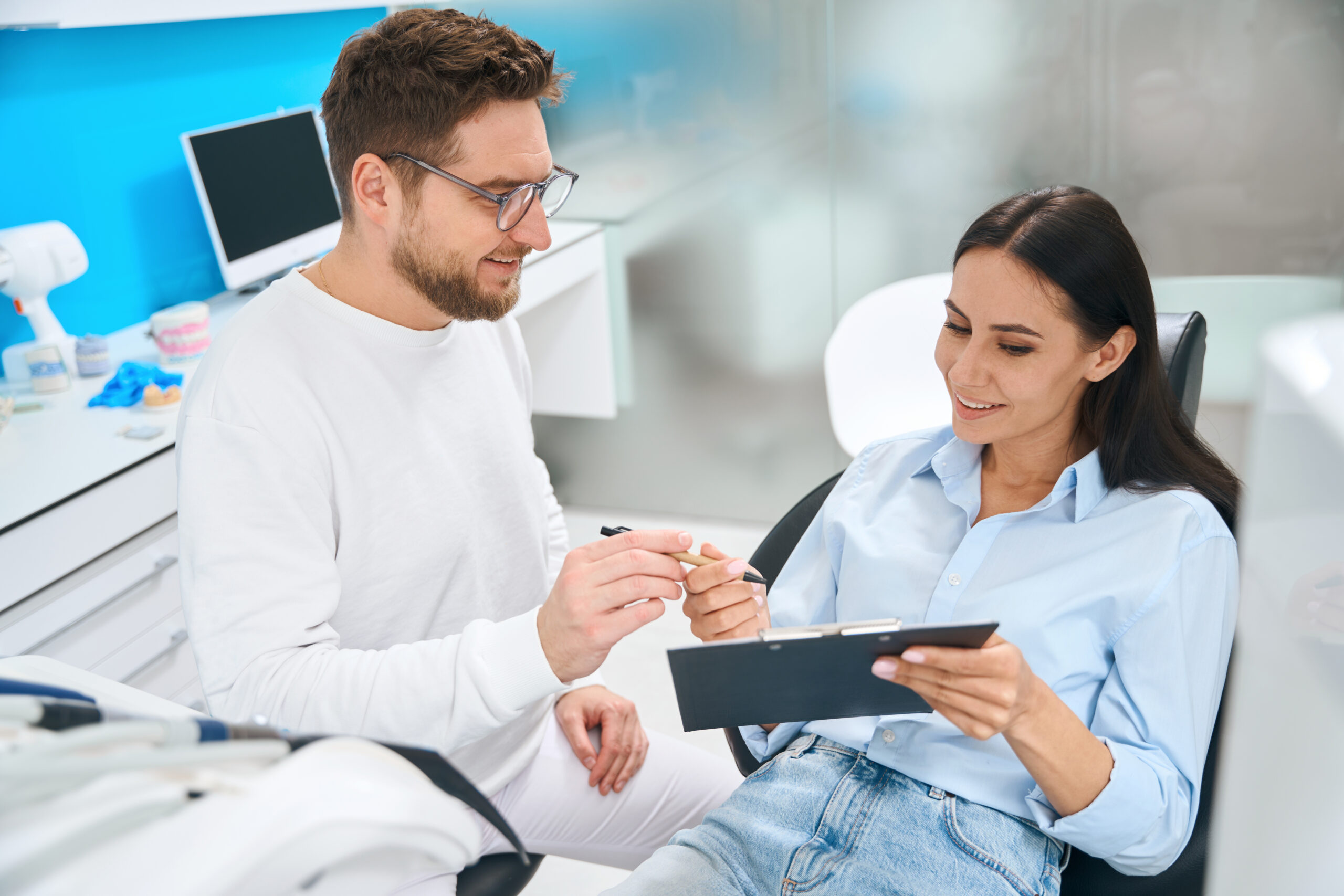 A dentist discussing a discount membership club for dental with a patient.