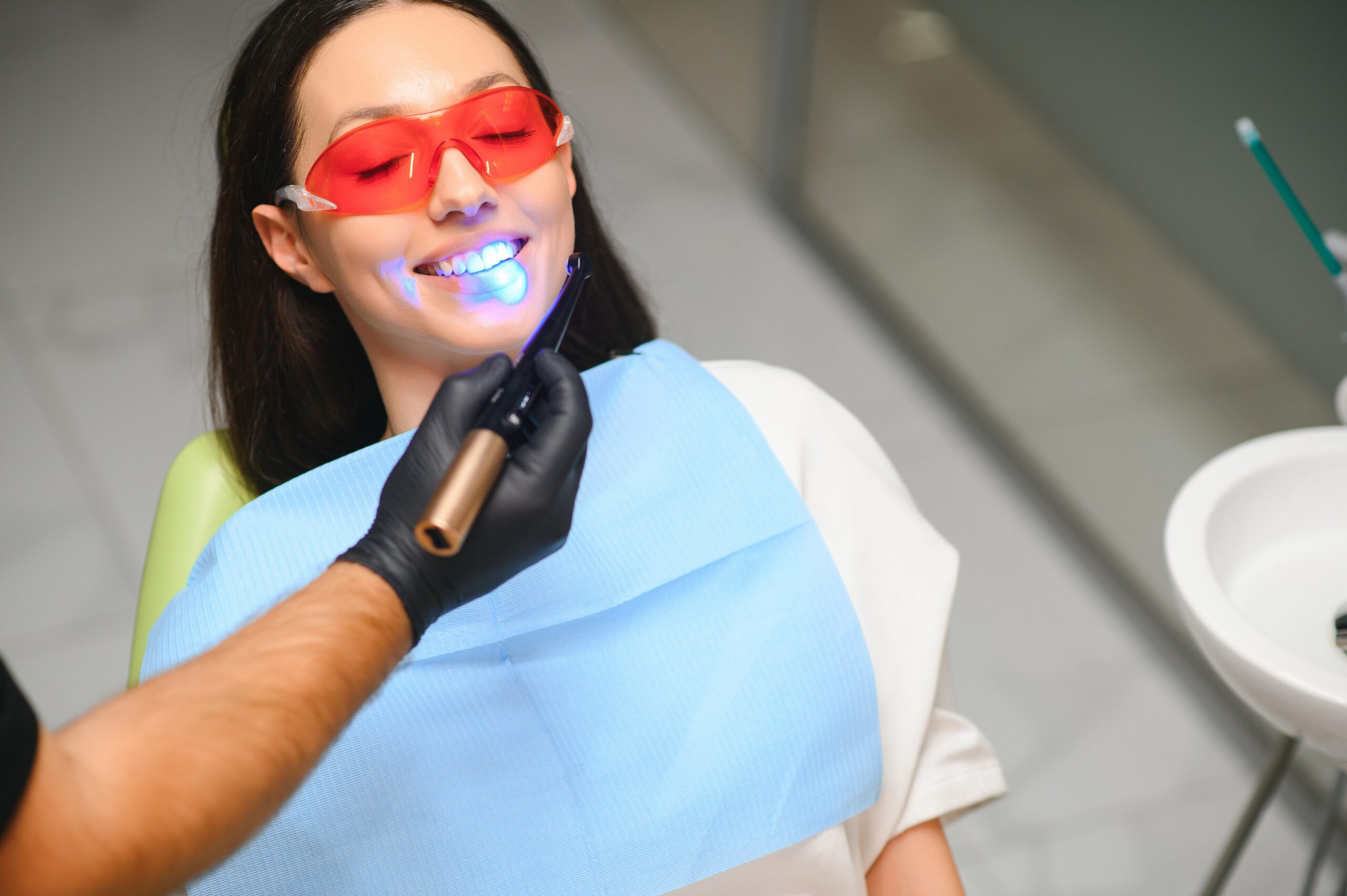 teeth whitening being performed on a woman