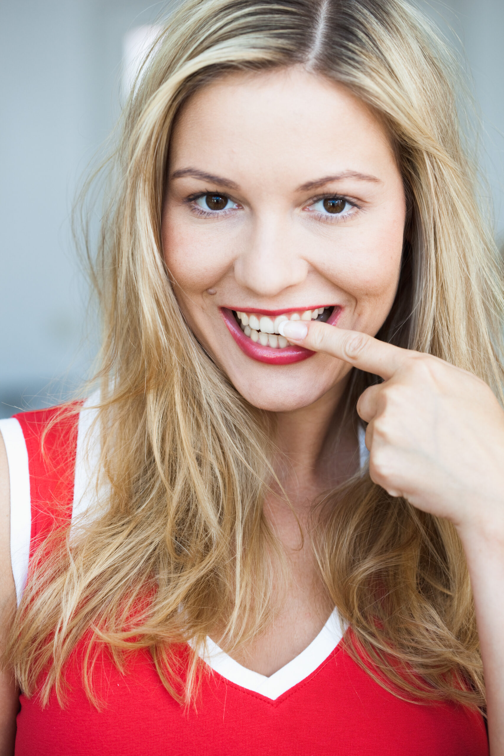 A woman happy with the benefits of teeth whitening.