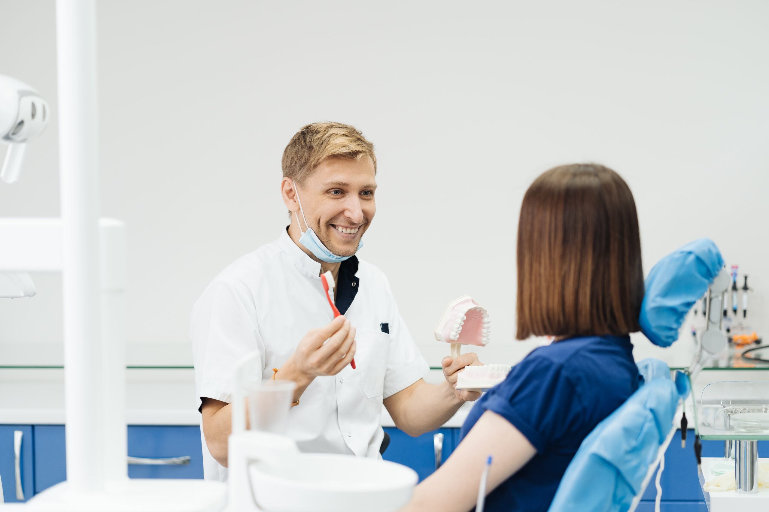 A woman asking a dentist, "How often can you whiten your teeth?"