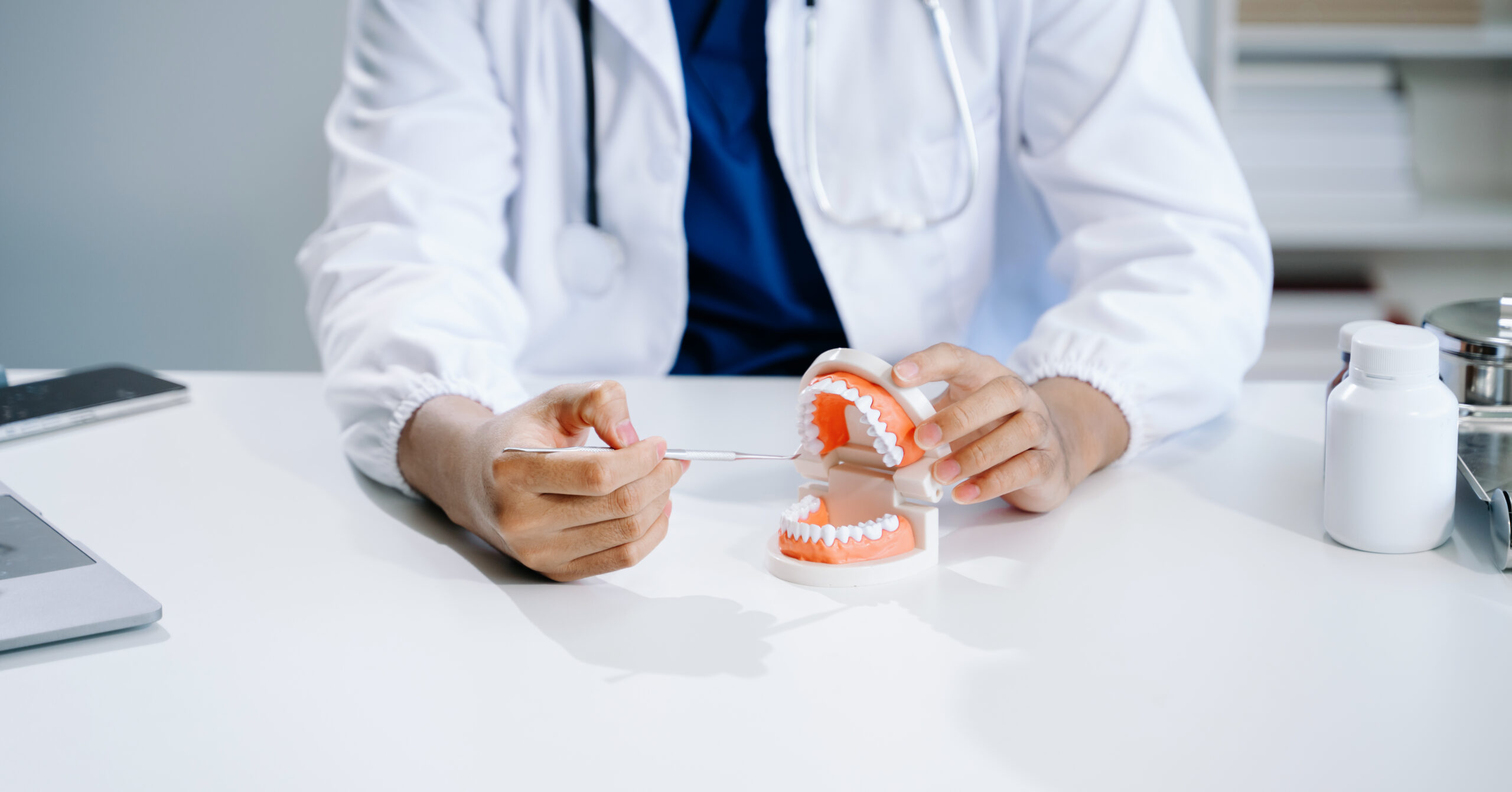 A dentist explaining how to fix broken dentures at home.