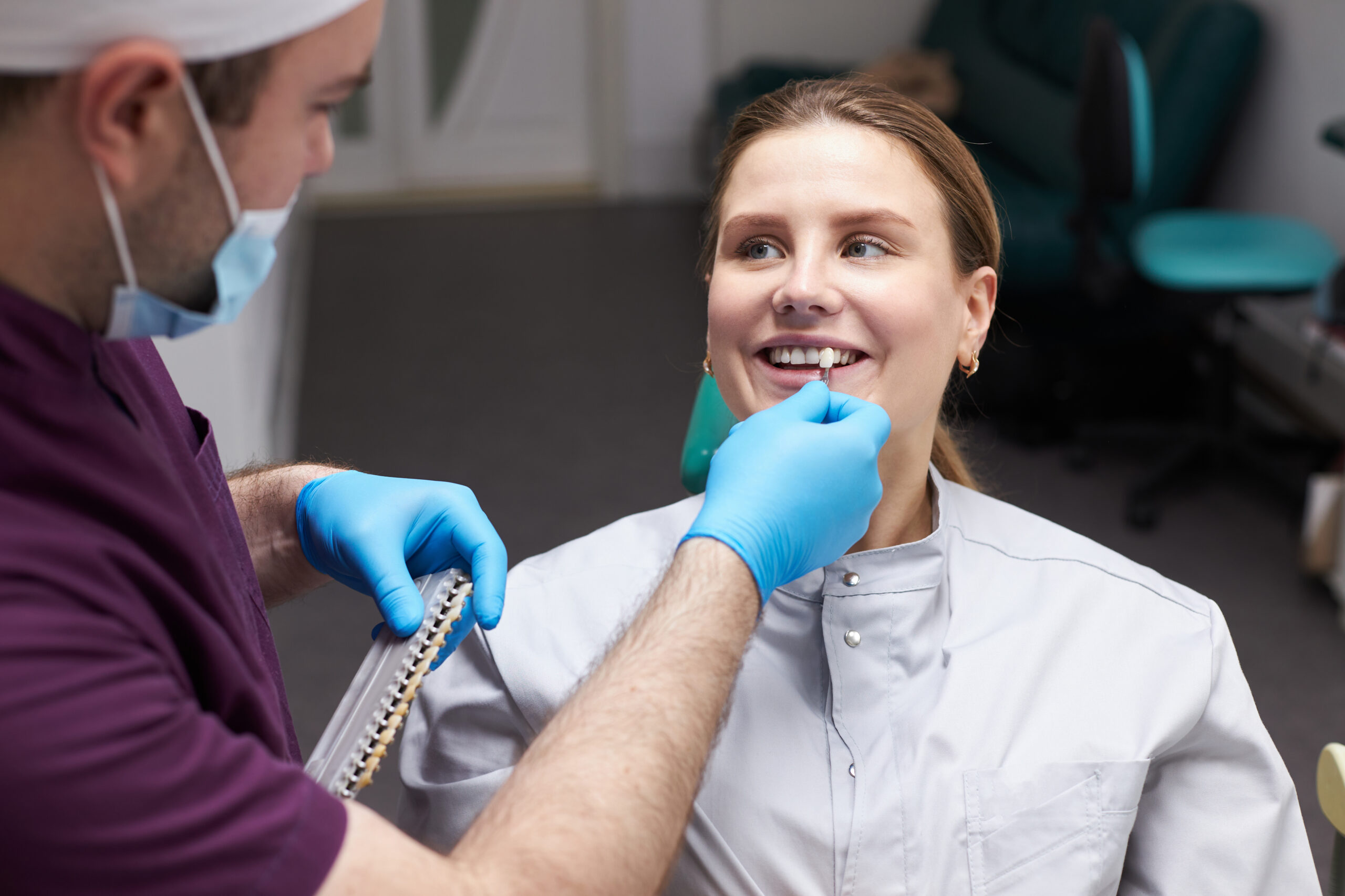 A woman learning about the brown spots on the back of her teeth.