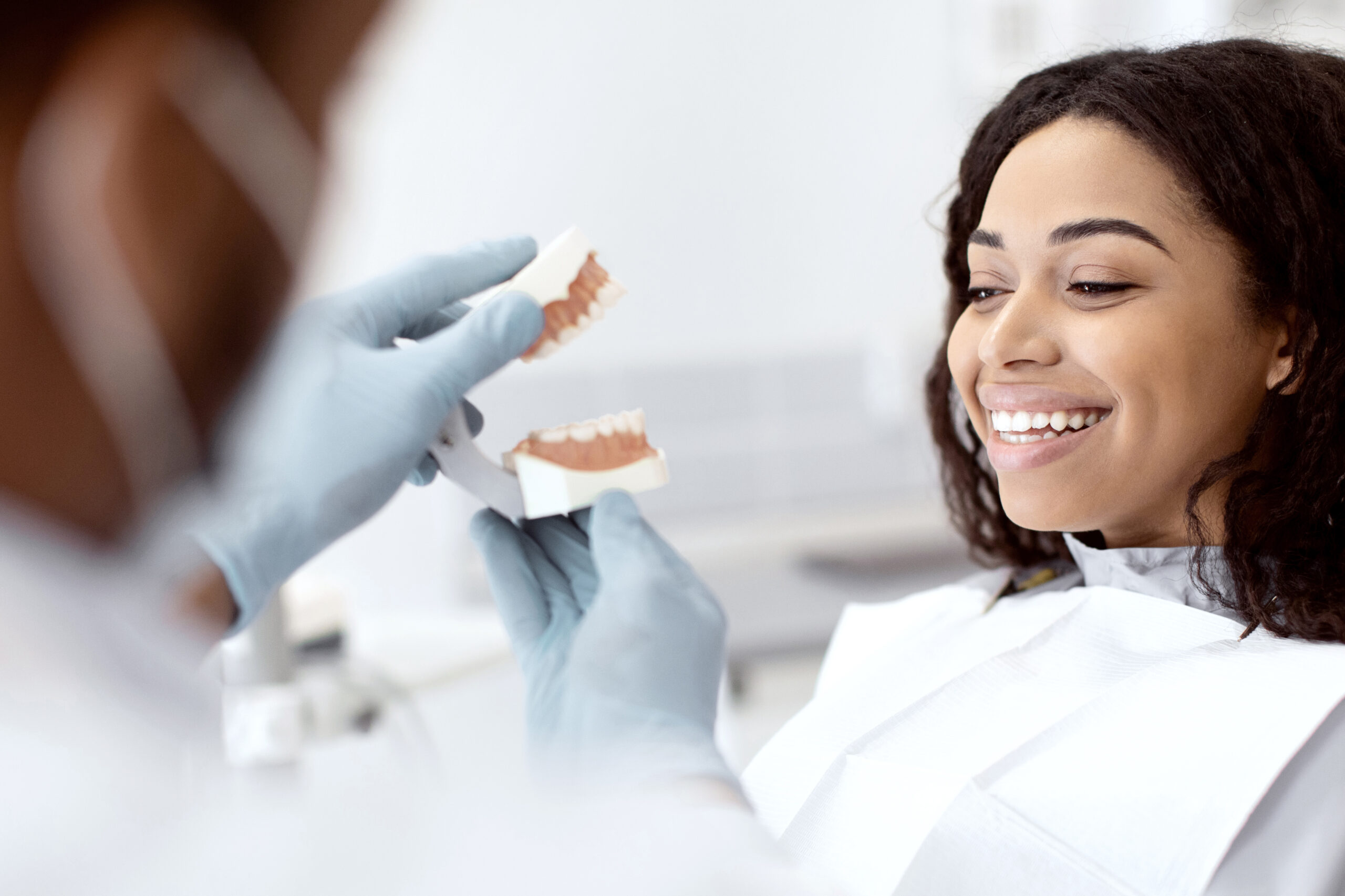 A woman learning about celebrities with veneers.