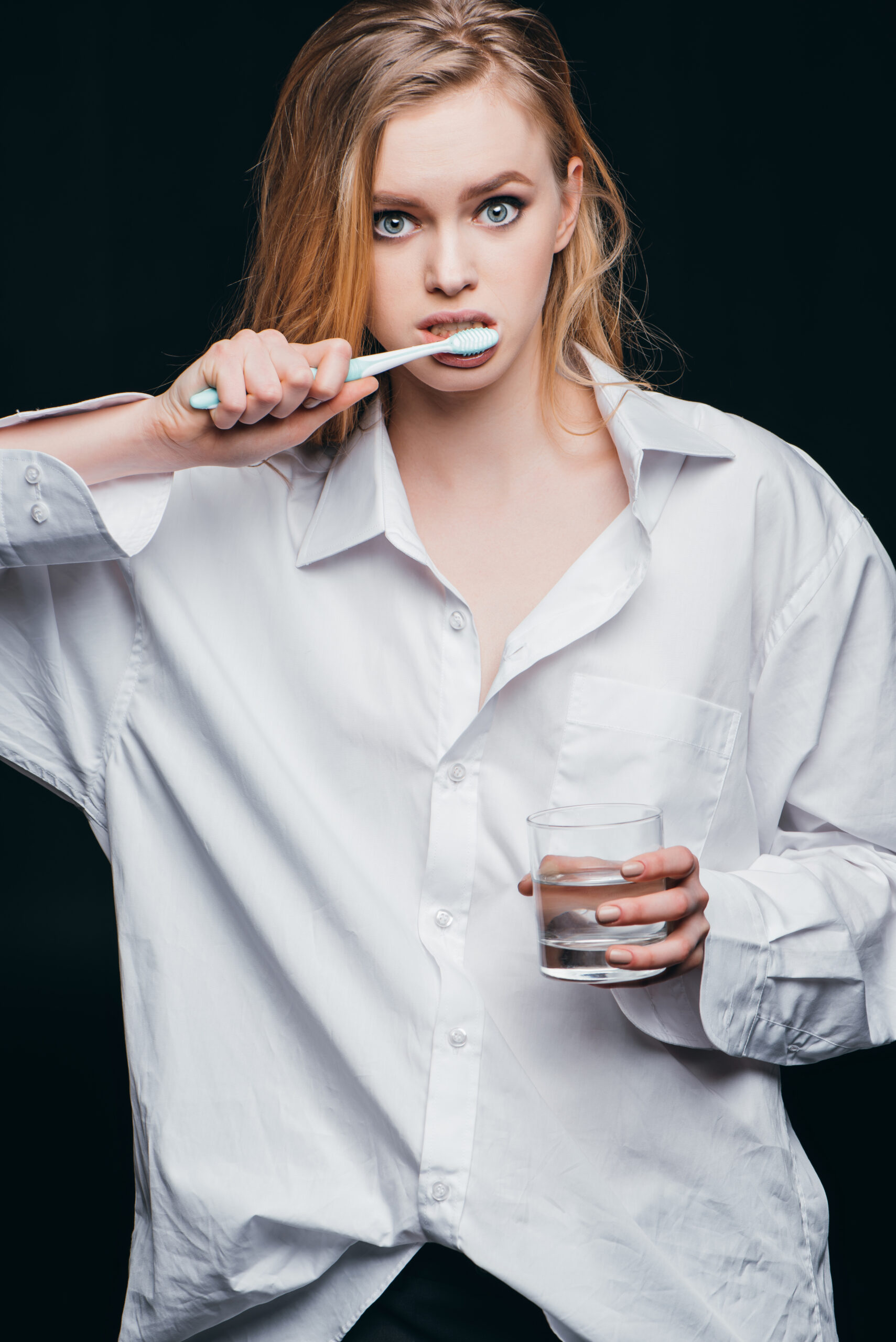A worried woman wondering, "how to fix stained teeth?"