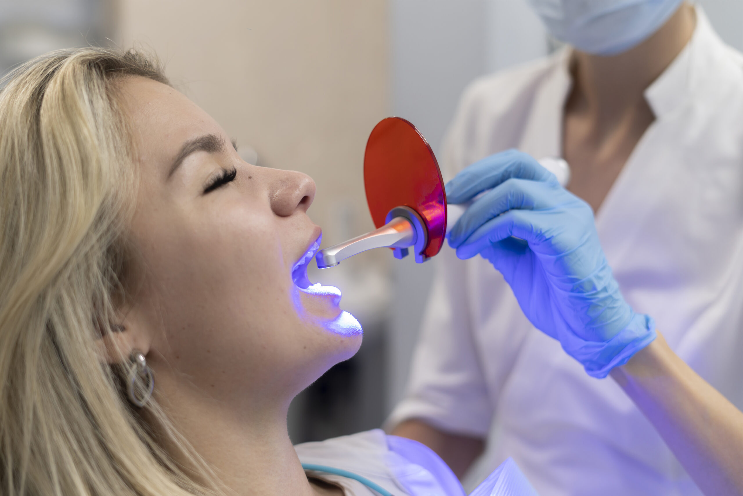 A young girl receiving safe teeth whitening.