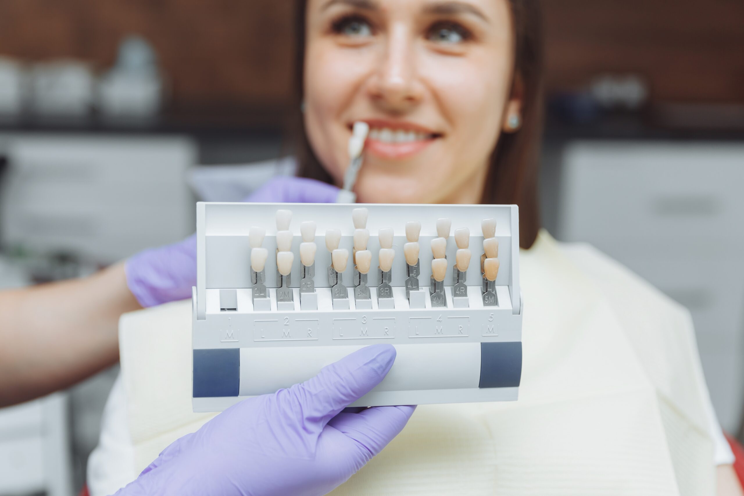 A woman being shown her natural tooth color.