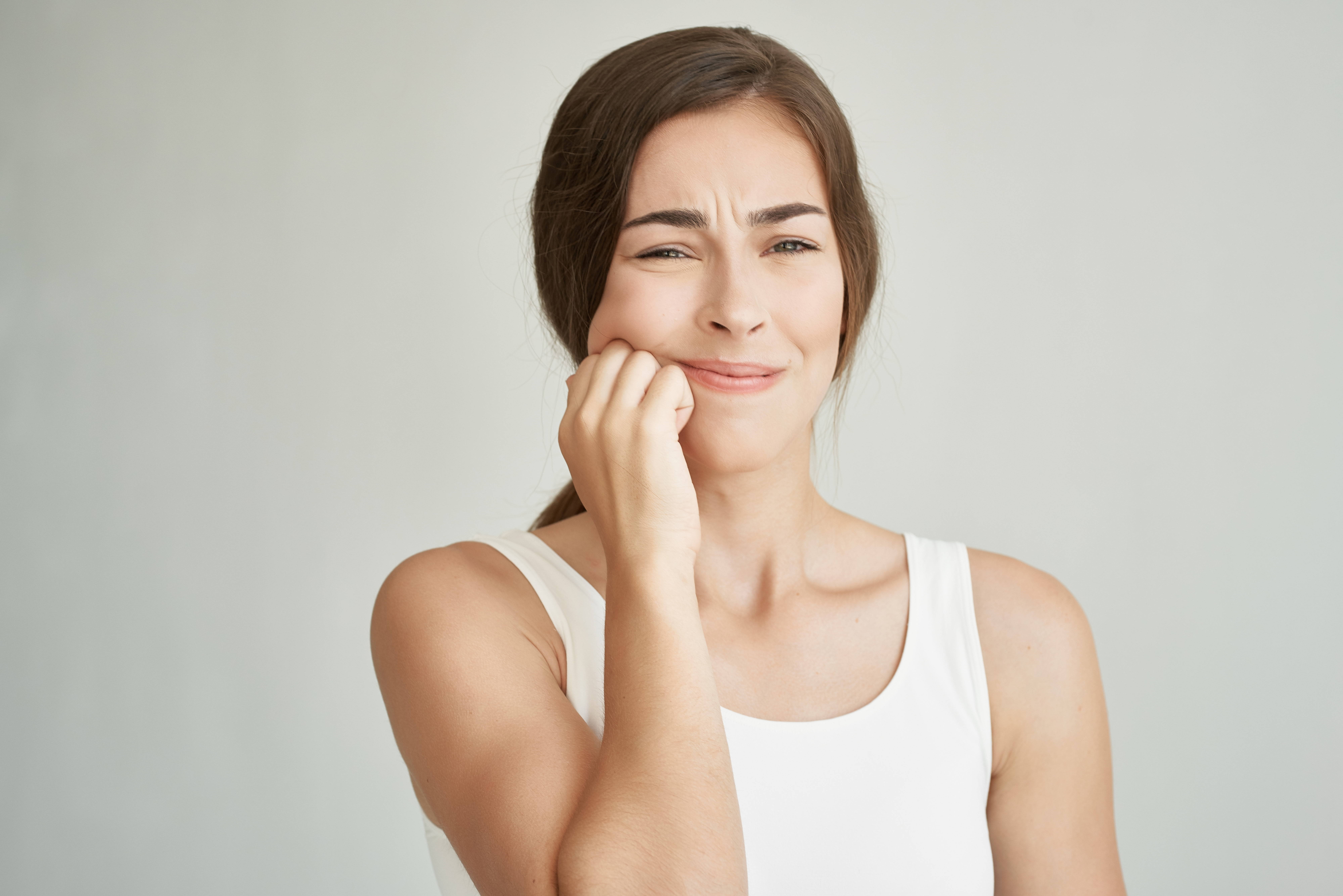 A woman experiencing referred tooth pain.